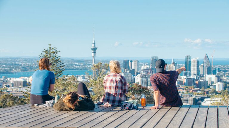 People on a deck overlooking the Auckland city skyline
